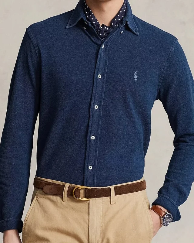 Portrait crop of the navy shirt including its collar, buttons, waist and cuffs